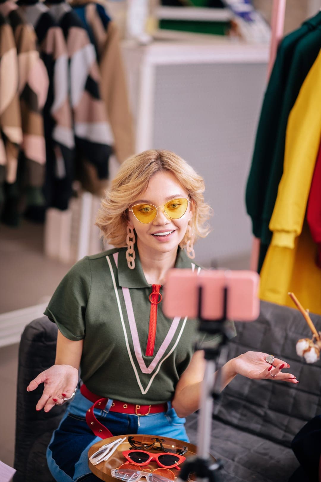 A creator filming a video about sunglasses on her phone